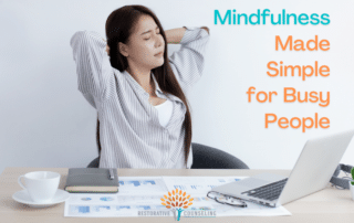A woman practicing mindfulness while sitting at her computer desk.